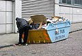 Man rummaging thought a skip.jpg